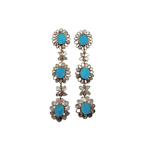 Pair of floral earrings with turquoise centers surrounded by diamond slices on a white background