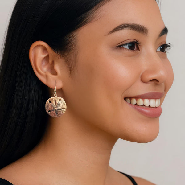 Antiqued Brass sand dollar earrings on model