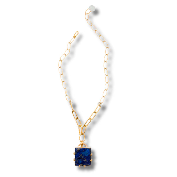A gold chain necklace featuring a square dark blue lapis lazuli pendant, displayed on a clean white background with a soft drop shadow.